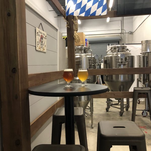 Jolly Roger Brewery Mooresville taproom with brewery seating at four separate tables in our afterdeck room. It can hold 15 under covid restriction guidelines, and you are sitting just next to the the brewery.
